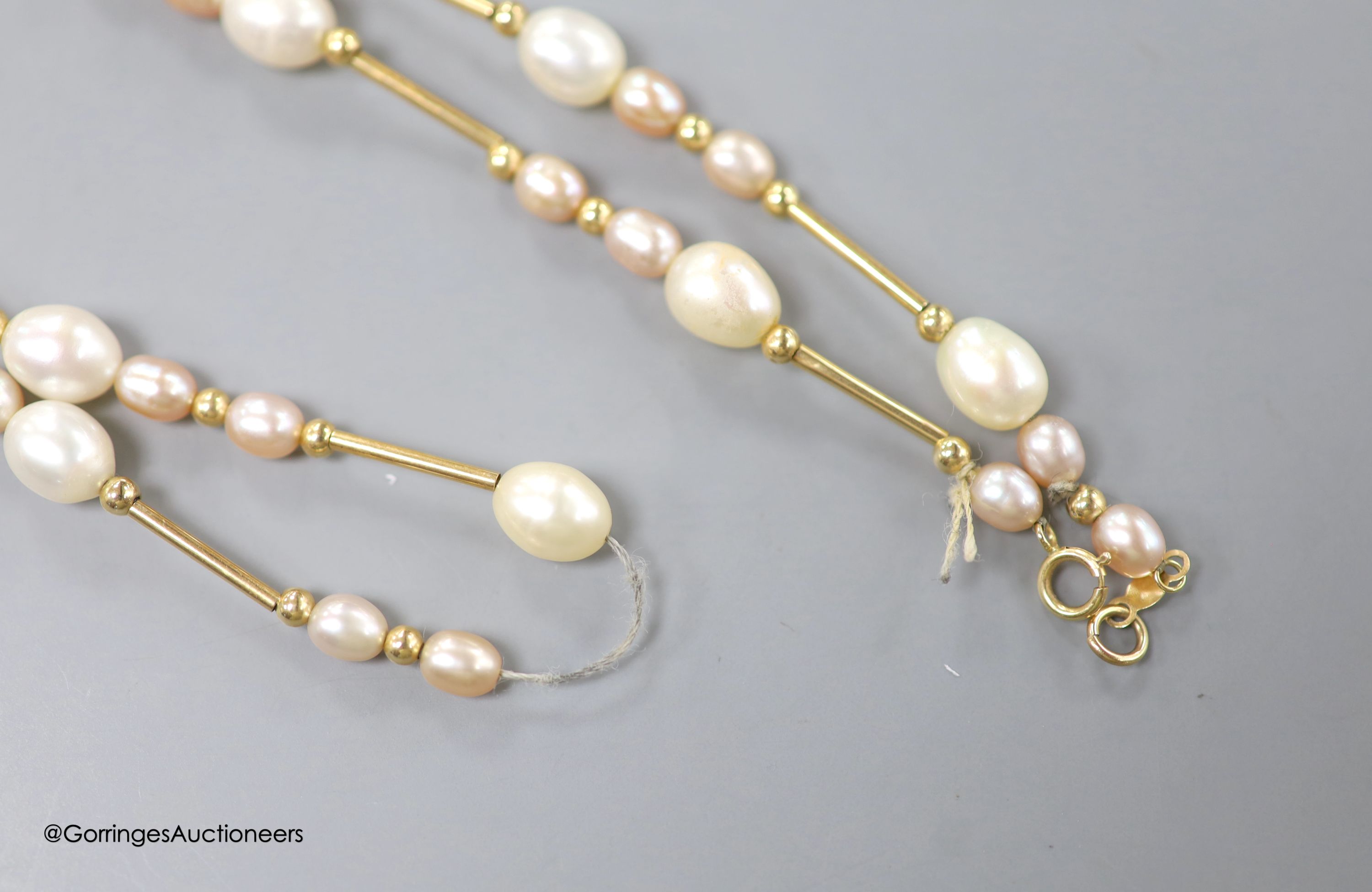 A modern 14kt yellow metal and graduated cultured pearl bar and cluster set necklace, 44cm, gross weight 11.3 grams.